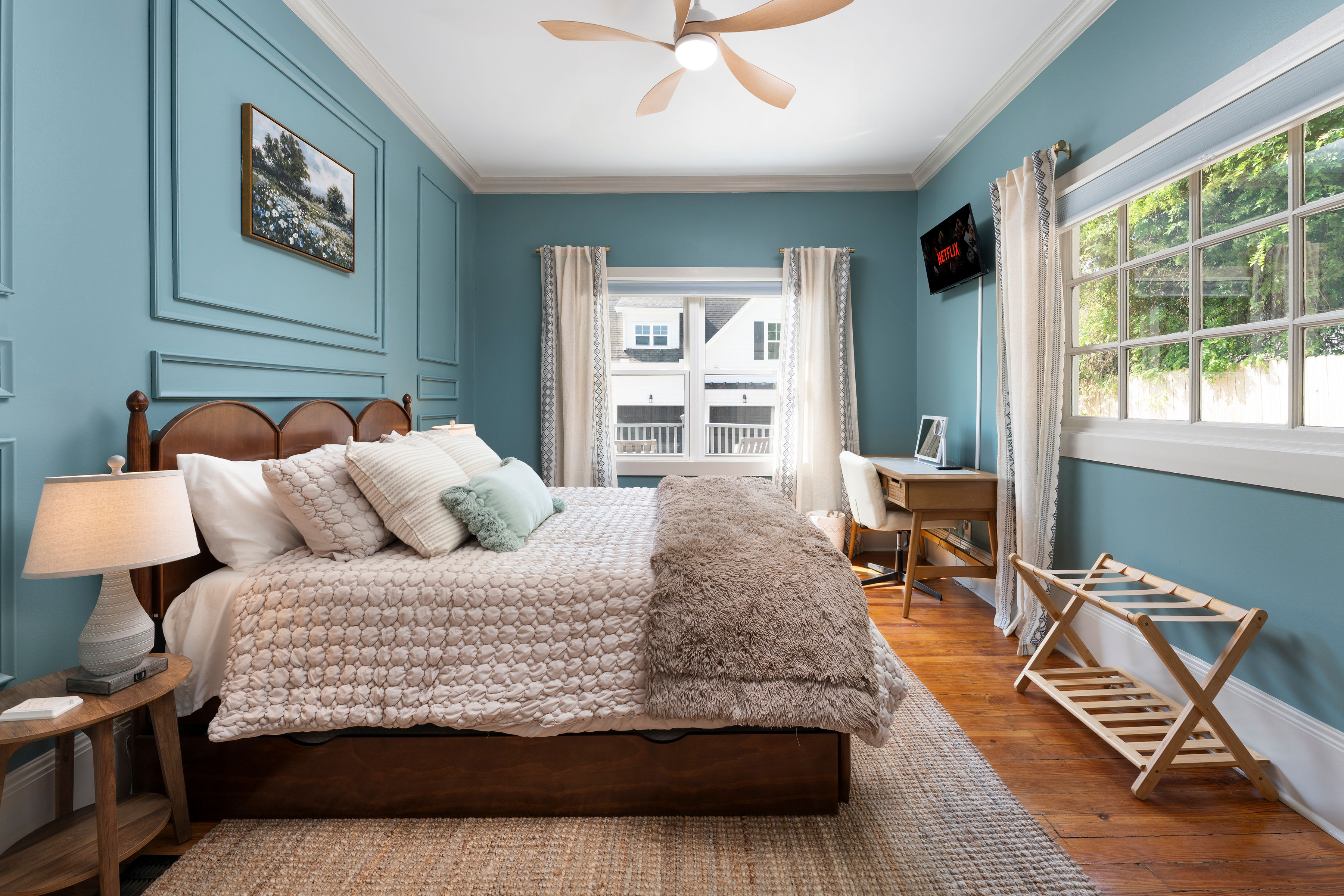 Teal bedroom with traditional headboard
