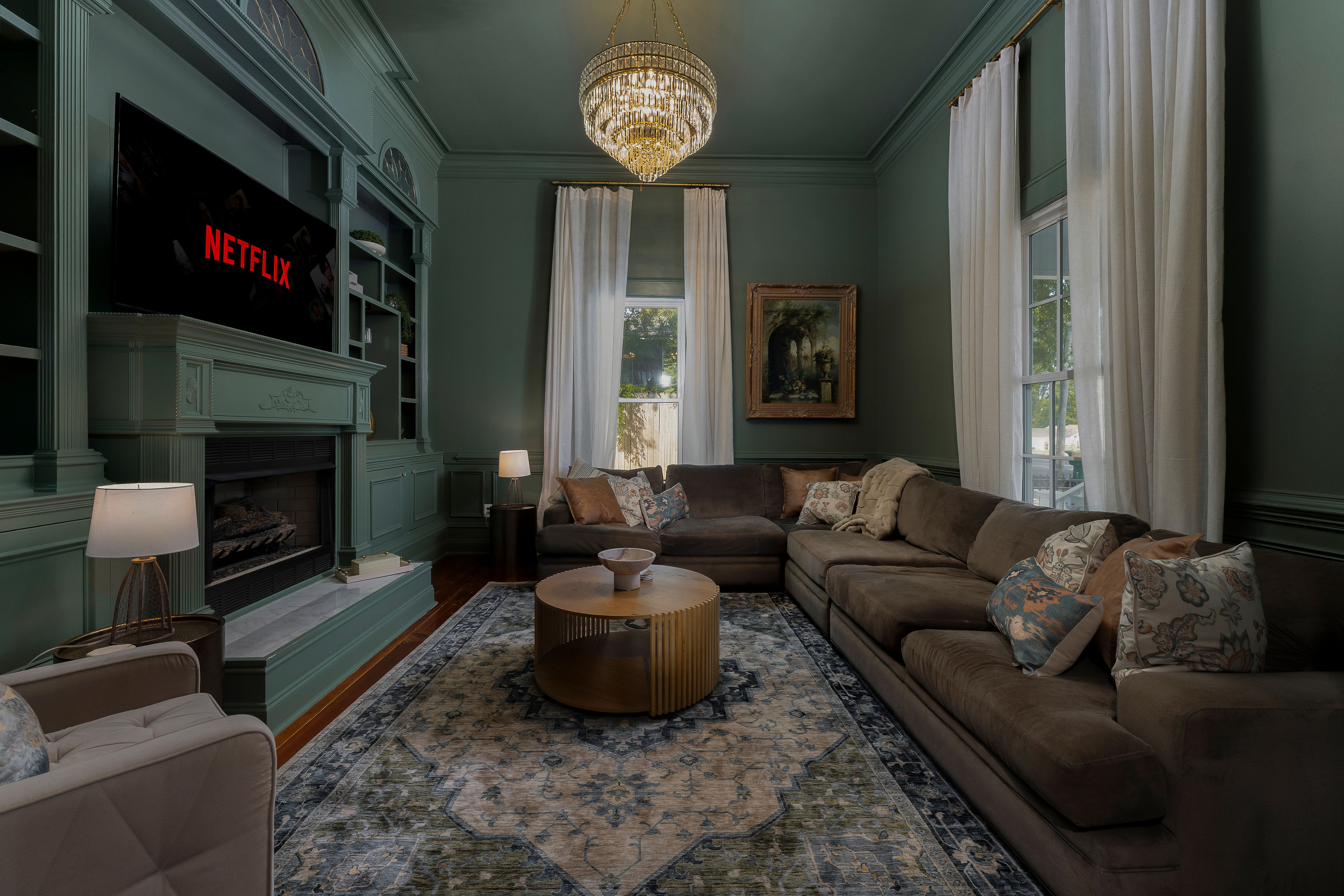 Emerald green living room with crystal chandelier